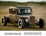 Classic hotrod on the beach in the sunset