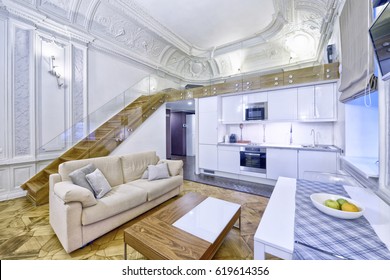 Classic interior design duplex apartment with white wall and ceiling moldings.
Interior design kitchen - living room in luxury new apartment.