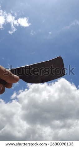 A classic iron machete placed under sunlight, highlighting its traditional design, metallic texture, and cultural heritage