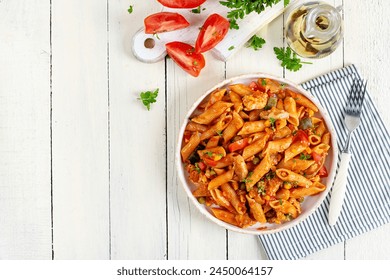 Classic italian pasta penne arrabbiata with vegetables on white wooden table. Penne pasta with sauce arrabbiata. Top view, overhead - Powered by Shutterstock