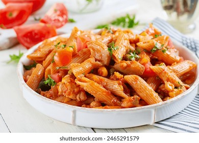 Classic italian pasta penne arrabbiata with vegetables on white wooden table. Penne pasta with sauce arrabbiata. - Powered by Shutterstock