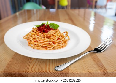 Classic Italian Pasta Spaghetti On Plate With Wooden Table Background. Simple And Easy Vegetarian Dish.