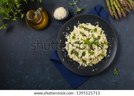 Classic Italian risotto with asparagus. Top view. Darkblue background.