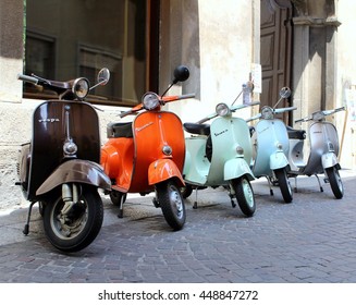 Classic italian scooters parked in ancient street old town at Treviglio Vintage festival. Piaggio Vespa Italy vintage scooters. Treviglio Lombardy Italy. July 2, 2016 