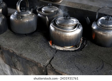 Classic kettle on a wood-burning stove - Powered by Shutterstock