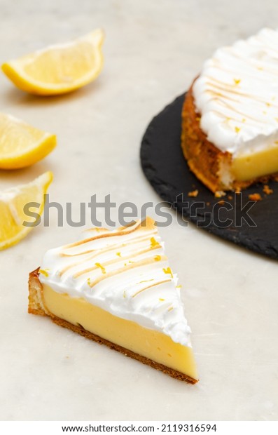 Classic Lemon Custard Tarte on white\
background. Lemon meringue pie. Tarte au\
citron.