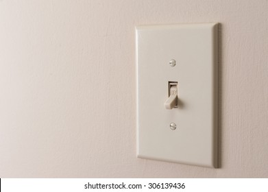 Classic Light Switch Hanging On The Wall