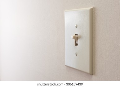 Classic Light Switch Hanging On The Wall