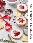 Classic Linzer Christmas Cookies with raspberry or strawberry jam on light background