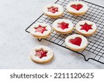 Classic Linzer Christmas Cookies with raspberry or strawberry jam on light background