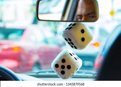 Classic Lucky Stuffed Dice Hanging From The Rearview Mirror Of A Car