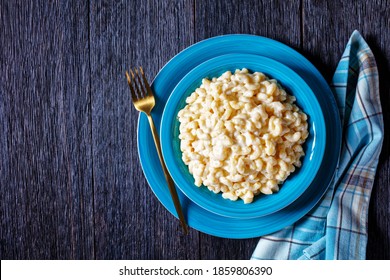 Classic Mac And Cheese In A Blue Bowl With Golden Fork And Napkin On A Wooden Table, Horizontal View From Above, Flat Lay, Free Space