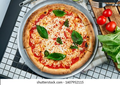 Classic Margarita Pizza With Mozzarella, Tomatoes And Basil. Italian Pizza In A Composition With Ingredients On A White Background. Top View. Food Flat Lay