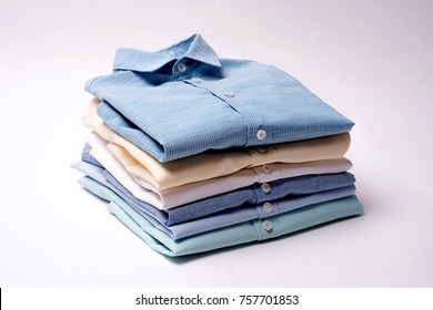 Classic Men's Shirts Stacked On White Background