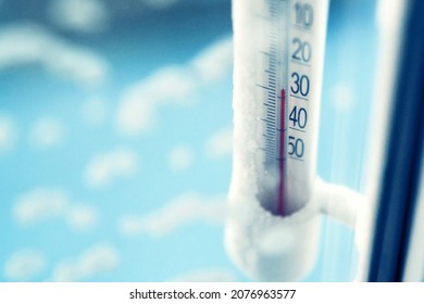 Classic mercury thermometer for measuring ambient temperature, hanging outside the window, with readings minus 30 degrees Celsius.