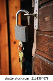 Classic Metal Padlock Hanging At Old Wooden Cottage, Keys Inside, Closeup Detail