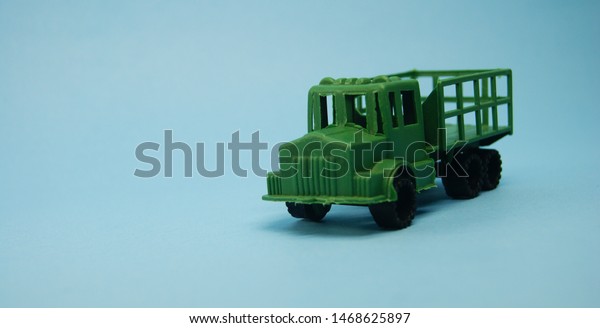 classic military truck off road model green\
color isolated on blue\
background