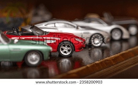 Classic model vehicles or toy vehicles. Miniature collection of automobiles. Retro car models on shelf. Retro style cars. Toy cars with retro design.