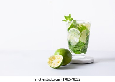 Classic Mojito Cocktail With Lime Isolated On White Light Background. Summer Freshness Beverage For Festive Party. Holiday Mocktail With Copy Space.