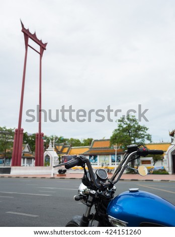 Classic Motocycle touring in front of Giant Brahmin swing is landmark in Bangkok, under blue sky in Thailand