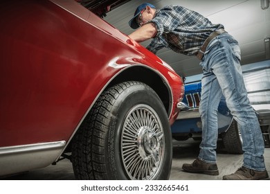 Classic Muscle Car Restoration Performed by Caucasian Professional Mechanic - Powered by Shutterstock