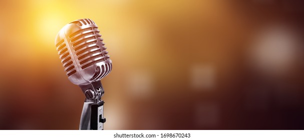 A classic musical microphone on blur colorful background