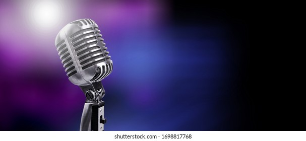 A classic musical microphone on blur colorful background