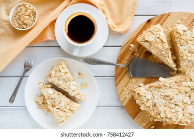 Classic Napoleon cake with coffee cup top view. Traditional millefeuille dessert with puff pastry and custard, russian cuisine treat, copy space