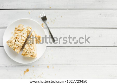 Classic Napoleon cake with coffee cup top view. Traditional millefeuille dessert with puff pastry and custard, russian cuisine treat, copy space