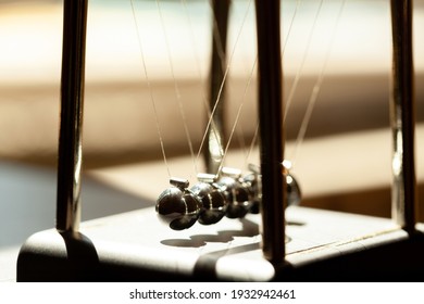 Classic Newtons Cradle In Sunlight, Shallow Dof, Metal Balls Still Macro, Extreme Closeup. Momentum, Movement Physics And Common Physical Laws, Simple Law Of Motion Abstract Concept, Nobody