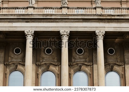 classic old architectural detail of stone columns, arched glass windows and balustrade. ornate decorative elements. front view. Buda castle inner court yard closeup in Budapest, Hungary. Baroque style