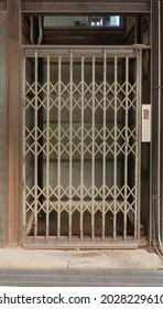 A classic old elevator lift with collapsible gate in hotel. Interior architectural element. Antique and vintage design.