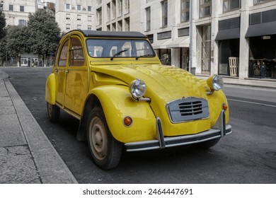 A classic old yellow French car parked on an empty street in the city of Verona  - Powered by Shutterstock