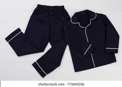 Classic Pajama For Young Boy. Navy Shirt And Pants Decorated With White Edging. Simple And Elegant.