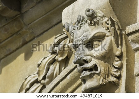 Classic Pan, or the devil, gargoyle feature carved in stone.