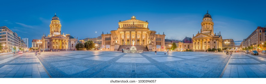 Classic panoramic view of famous Gendarmenmarkt square with historic Berlin Concert Hall and German and French Churches in twilight at dusk, Berlin, Germany