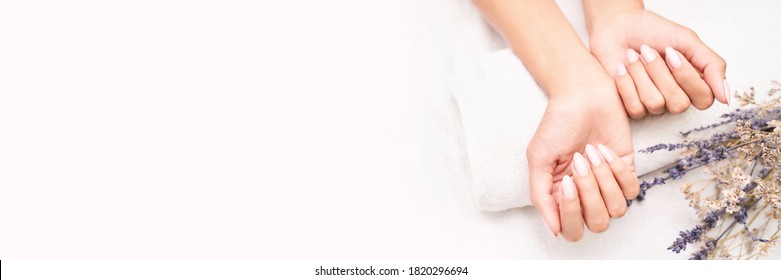Classic pink wedding nail manicure on white backdrop. Spa treatment concept. Towel background. Natural hygiene. Health care. Beauty spa salon. Salon procedure Woman body care. Lavender flower