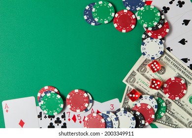 Classic Playing Cards, Chips, Red Dice And Dollars On Green Background With Place For Text. Gambling And Casino Concept. Flat Lay Design.