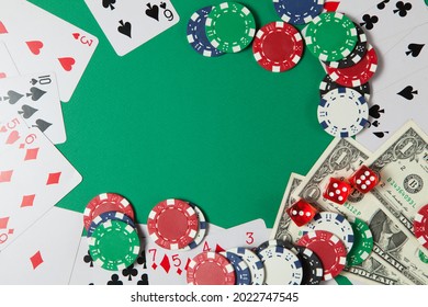 Classic Playing Cards, Chips, Red Dice And Dollars On Green Background With Place For Text. Gambling And Casino Concept. Flat Lay Design.