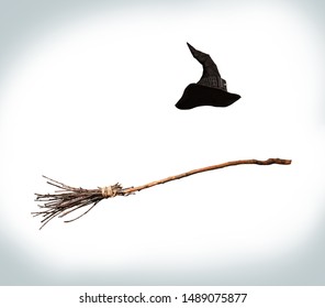 Classic Pointed Witch Hat And Flying Broom Flying On A White Background