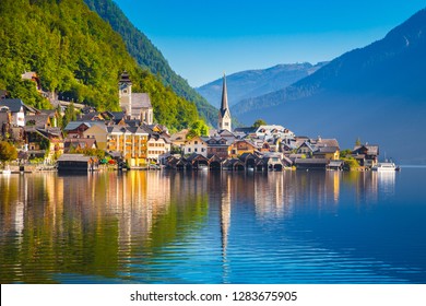 Classic postcard view of famous Hallstatt lakeside town in the Alps in scenic golden morning light at sunrise on a beautiful sunny day in summer, Salzkammergut region, Austria