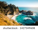 Classic postcard view of famous McWay Falls in scenic golden evening light at sunset on a beautiful sunny day with blue sky in summer, Julia Pfeiffer Burns State Park, Big Sur, California, USA