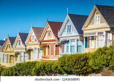Classic postcard view of famous Painted Ladies, a row of colorful Victorian houses located near scenic Alamo Square, on a beautiful sunny day with blue sky in summer, San Francisco, California, USA