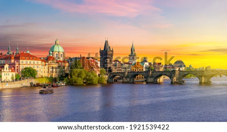 Classic Prague panorama with Old Town Bridge Tower and Charles bridge over Vltava river at sunset, Czech Republic