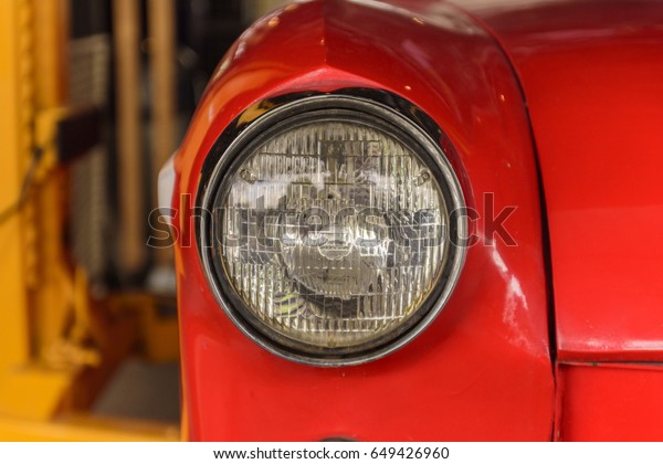 Classic red car headlights.old car wallpaper\
and backgruond.