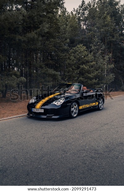 Classic retro old\
Porsche 911 996 Turbo Cabrio in the forest without a roof. Kyiv,\
Ukraine - November\
2021.