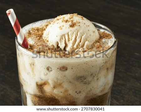 Classic Root Beer Float: an iconic American treat mixing fizzy root beer with creamy vanilla ice cream, cherished for its nostalgic sweetness and popularity at diners, summer parties celebrations