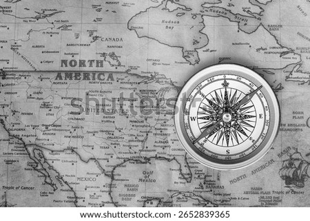 Classic round compass on background of old vintage map of world as symbol of tourism with compass, travel with compass and outdoor activities with compass