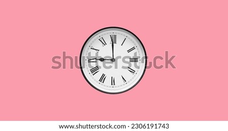 Classic round wall clock with roman numerals isolated on pink background