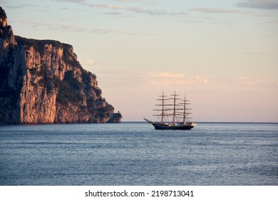 Classic Sailboat Anchored In The Bay At Sunrise